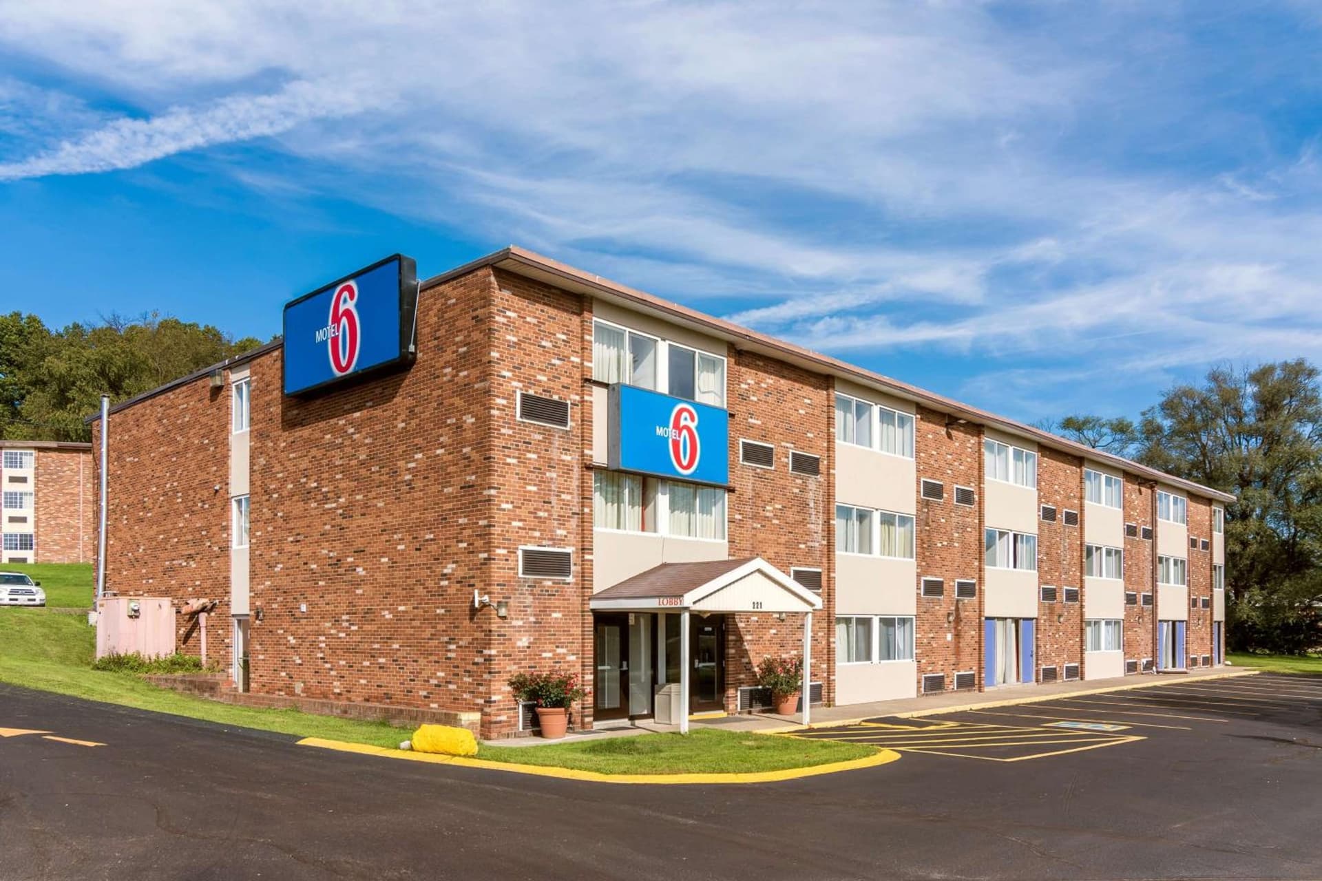 Motel 6-New Stanton, PA featured exterior or lobby in New Stanton, PA — similar hotel