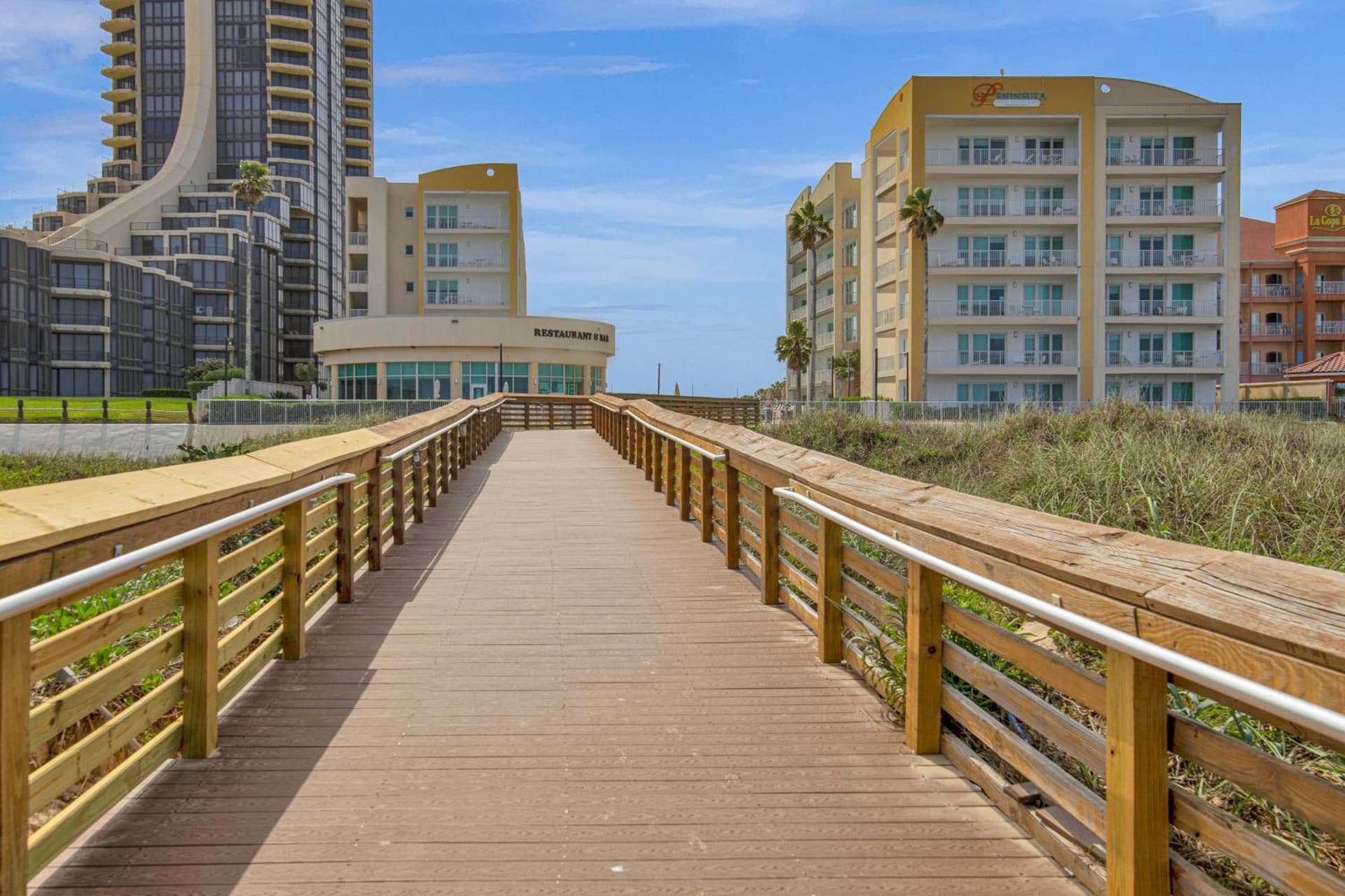 Peninsula Island Resort & Spa - Beachfront Property at South Padre Island featured exterior or lobby in South Padre Island, TX — similar hotel