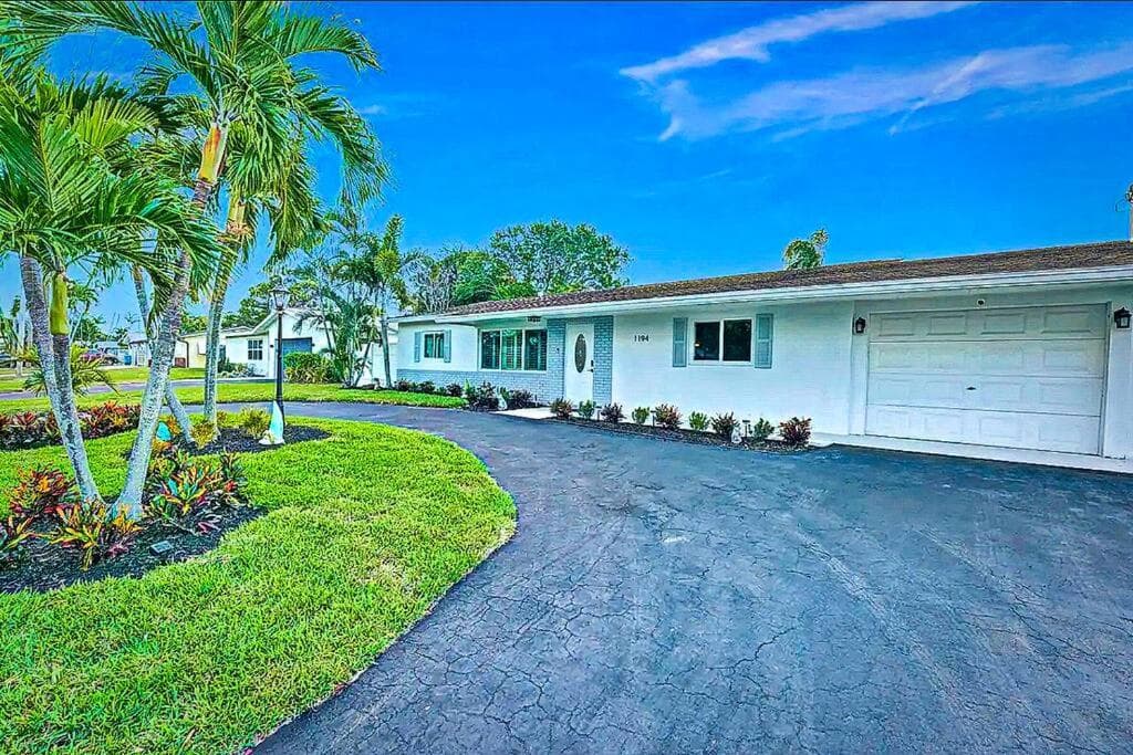 NEW Waterfront Tropic Oasis - Heated Pool, Canal, Dock, Air Hockey featured exterior or lobby in Boynton Beach, FL — similar hotel