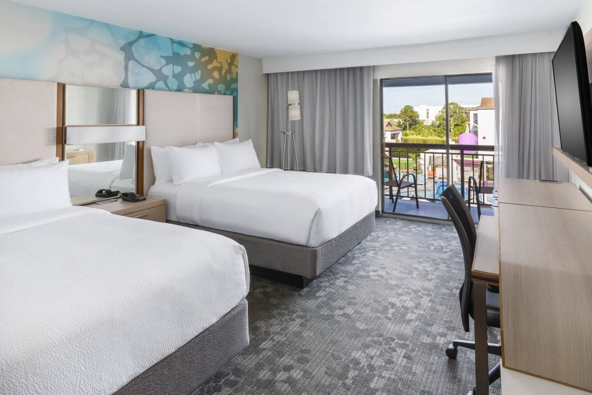 Queen Room with Two Queen Beds and Balcony at Courtyard by Marriott Orlando Lake Buena Vista at Vista Centre in Orlando, FL