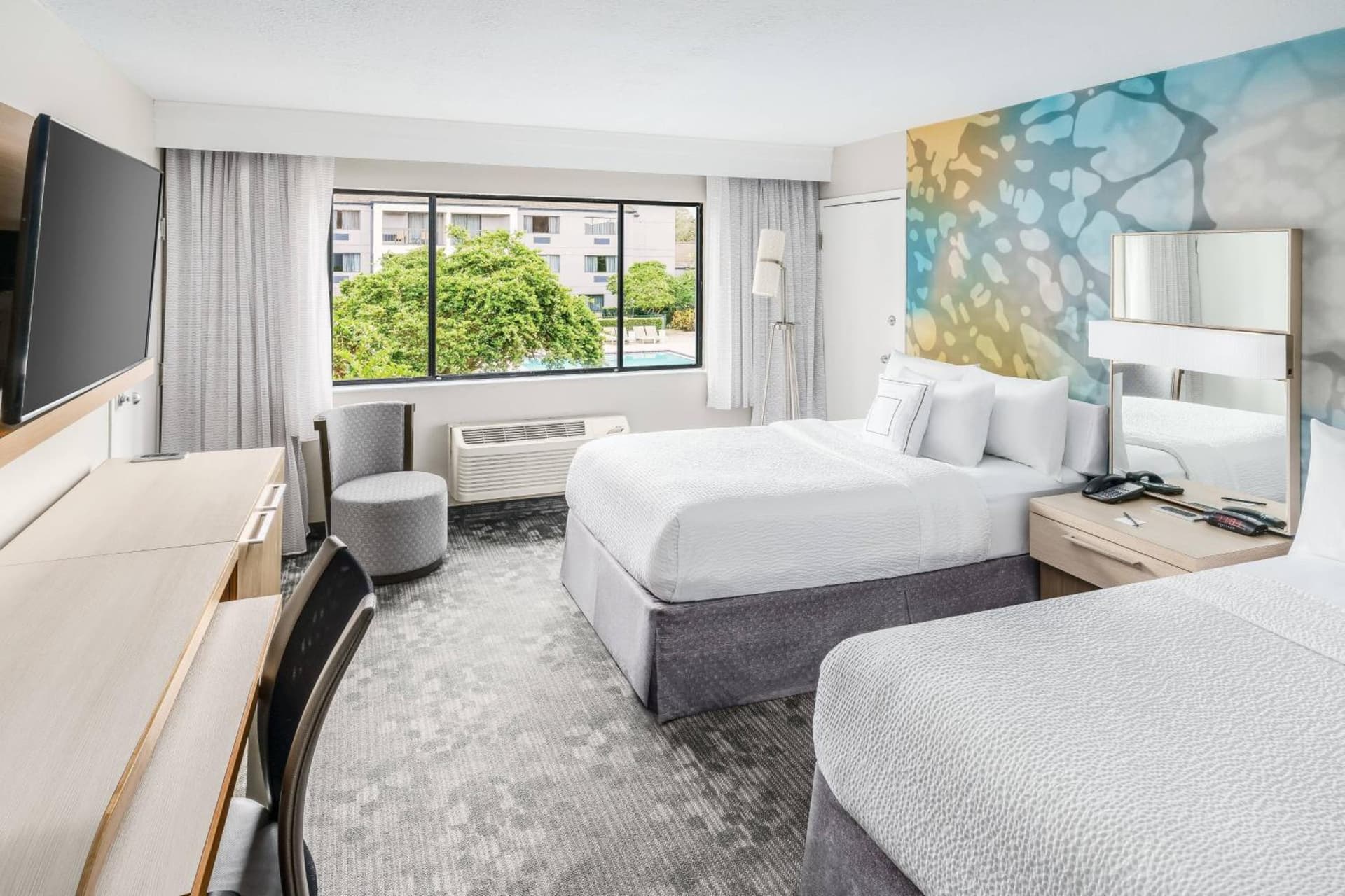 Queen Room with Two Queen Beds - Hearing Accessible at Courtyard by Marriott Orlando Lake Buena Vista at Vista Centre in Orlando, FL